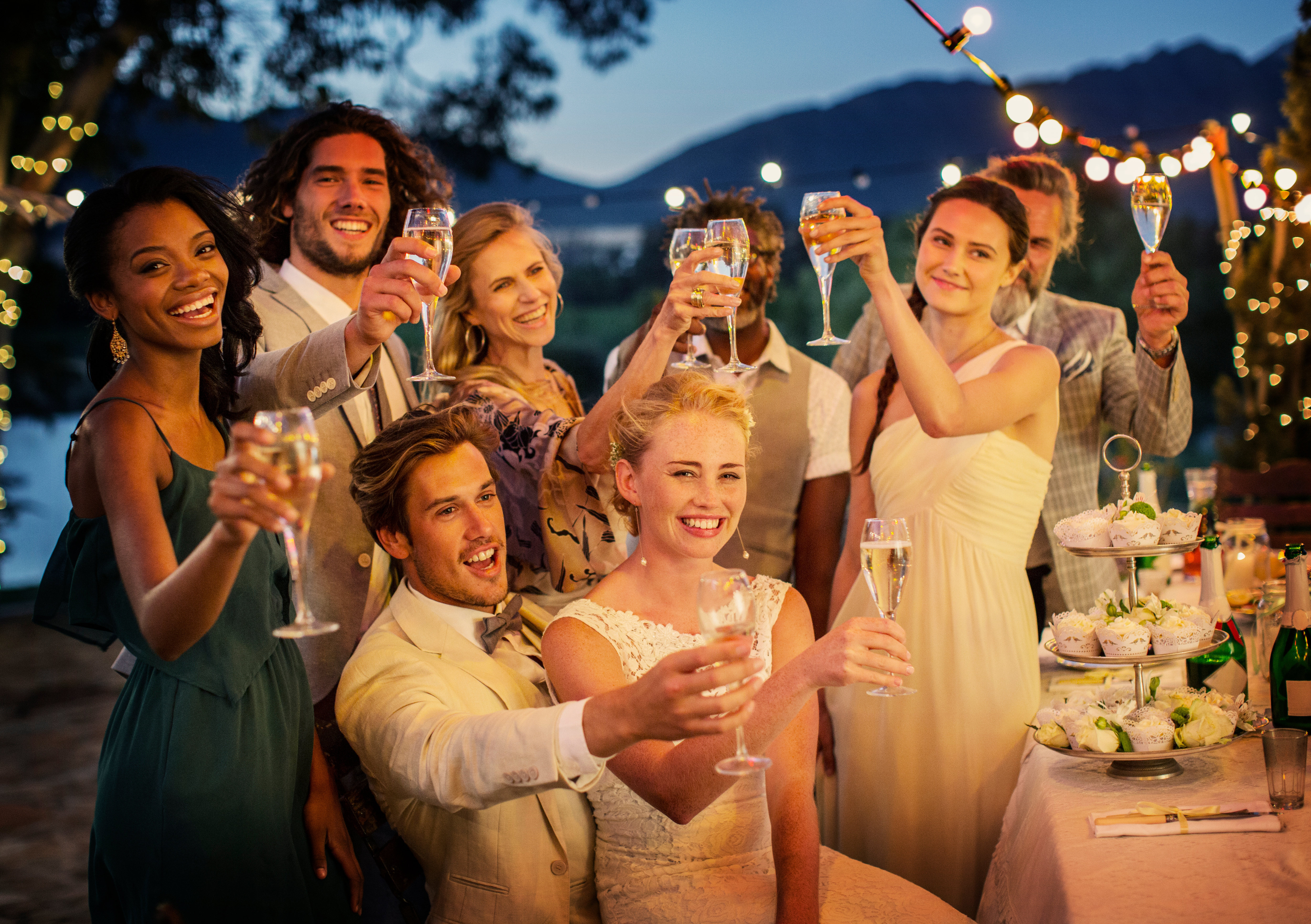 bride and groom with guests at an outdoor wedding reception